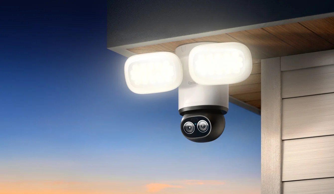 A floodlight security camera mounted on a wall